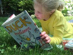 Girl reading the book Duck for President